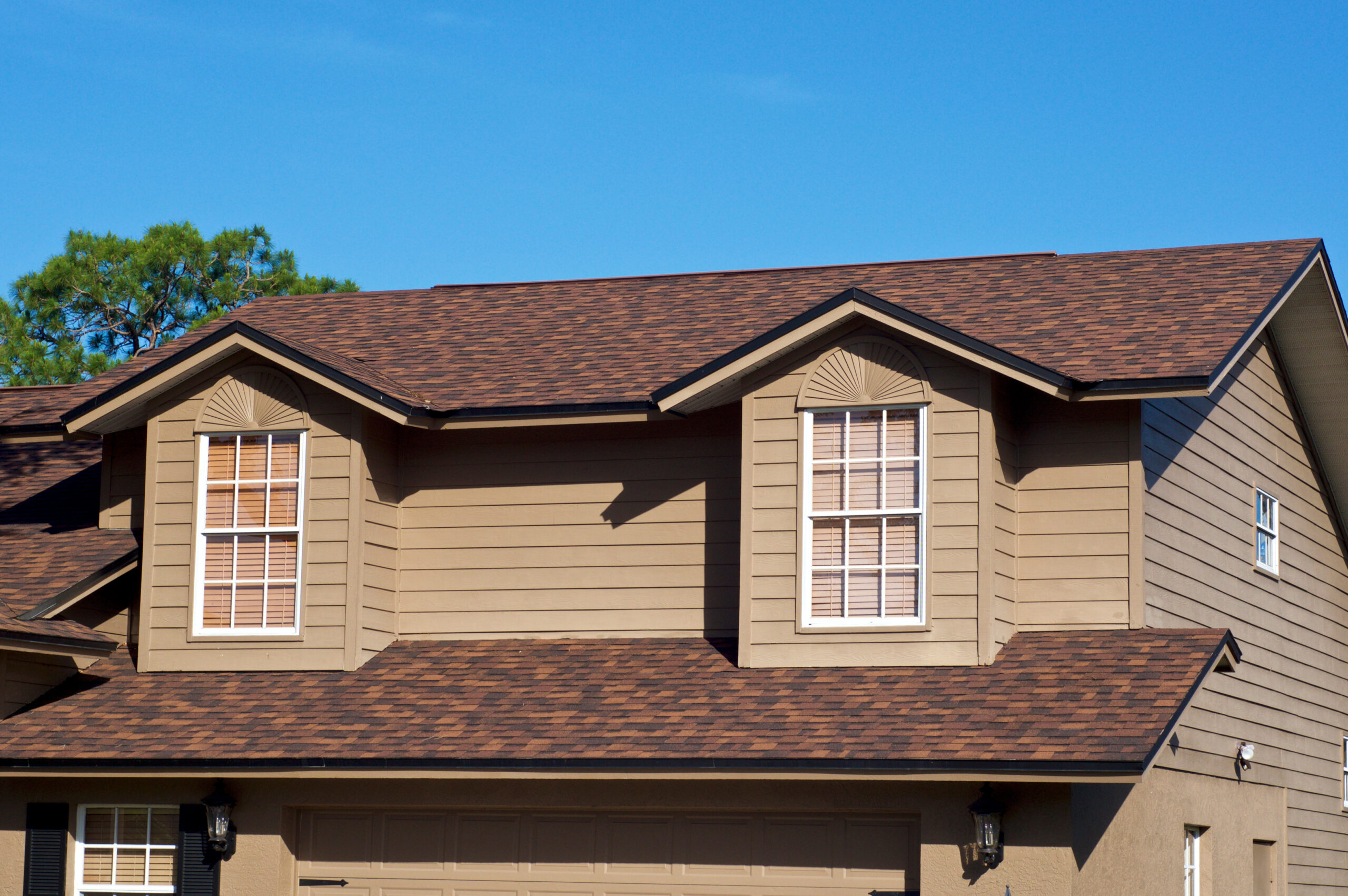 Brown two-story house with a shingle roof