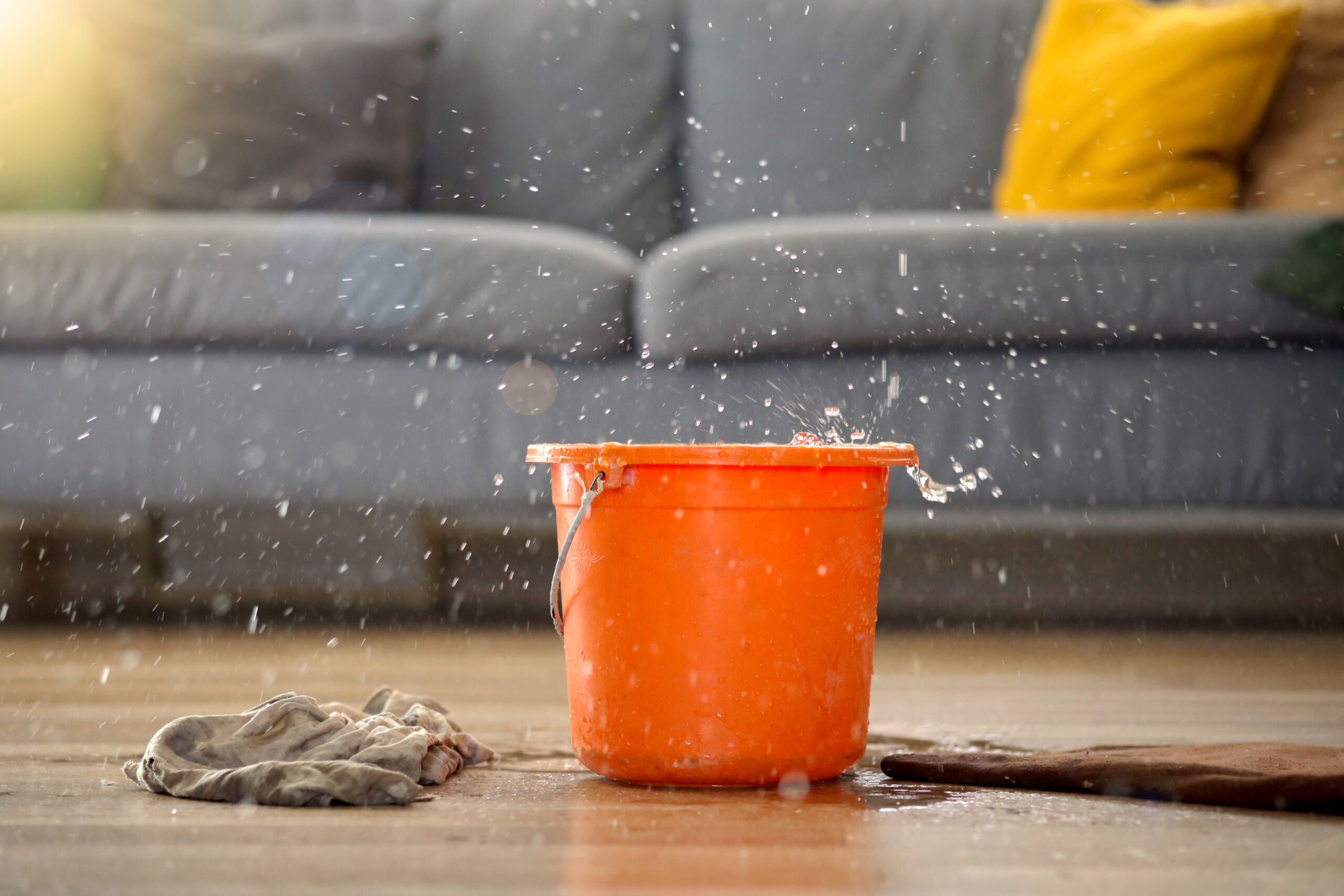 Water leak falling into a red bucket