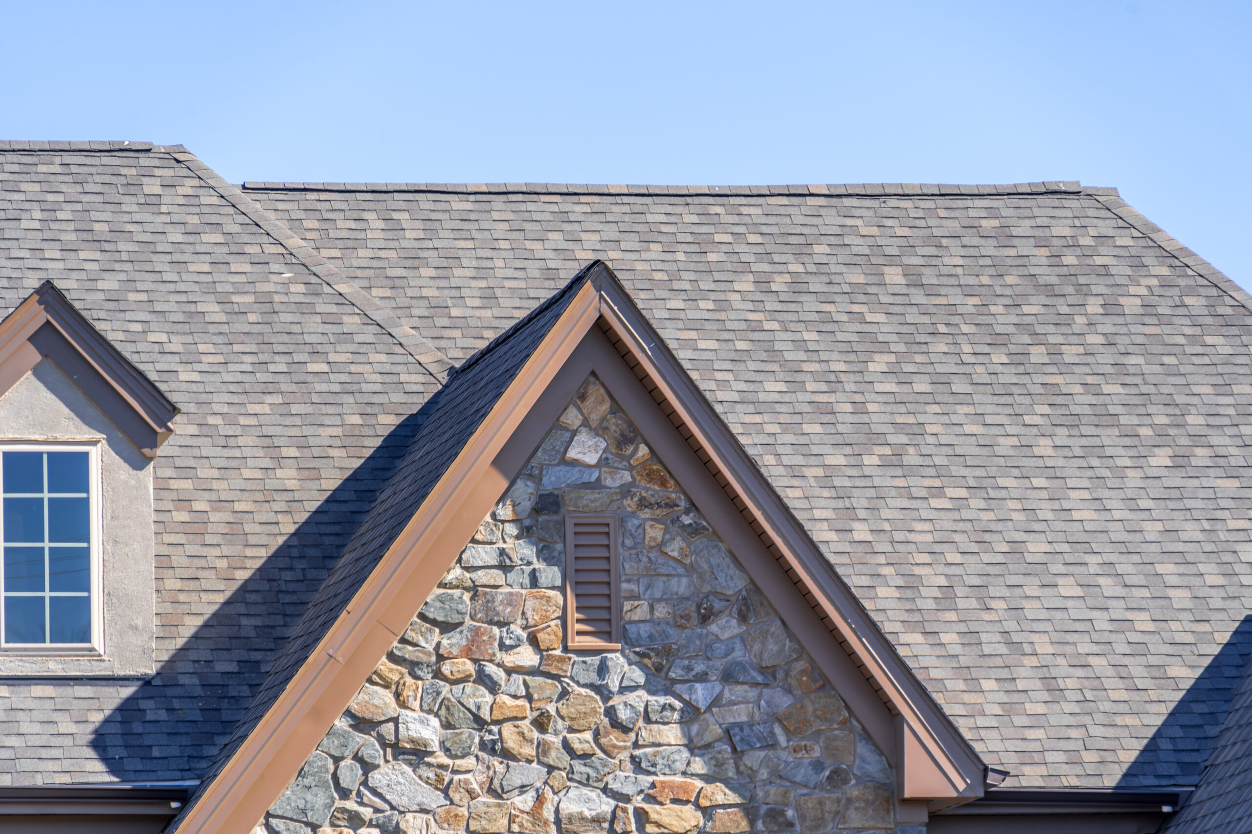Shingle roof on a multi-story stone house
