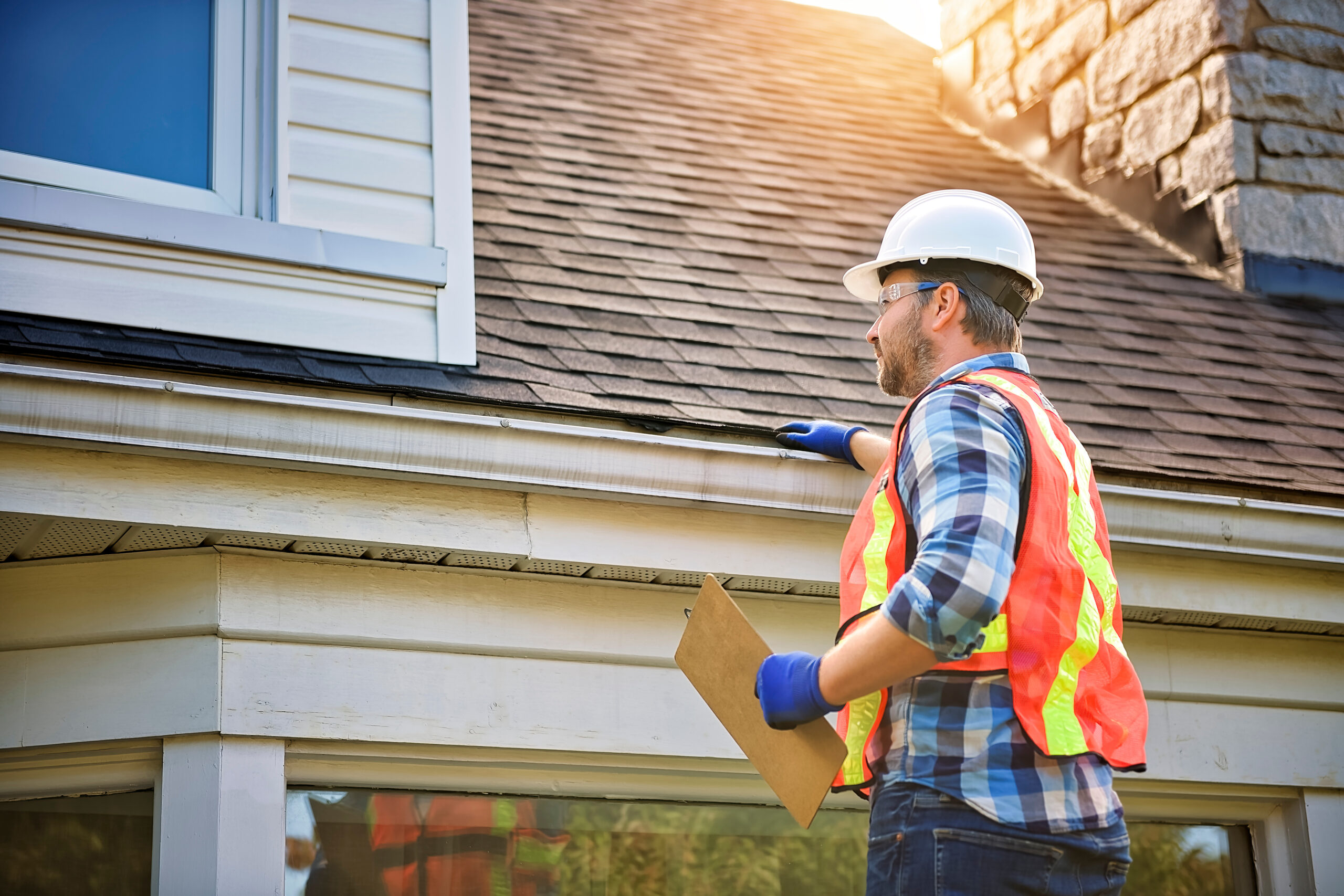 Roof inspector looking at a shingle roof