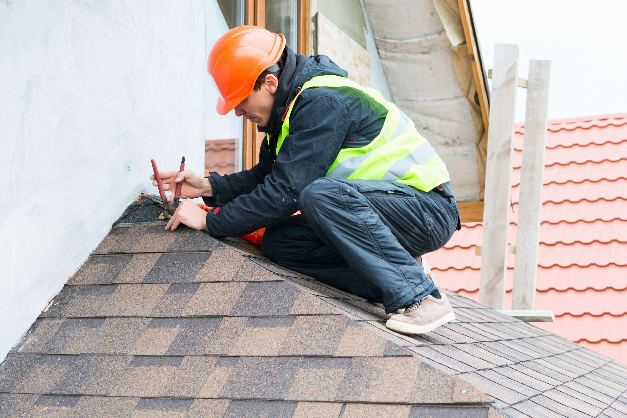 Roofer making repairs to a roof