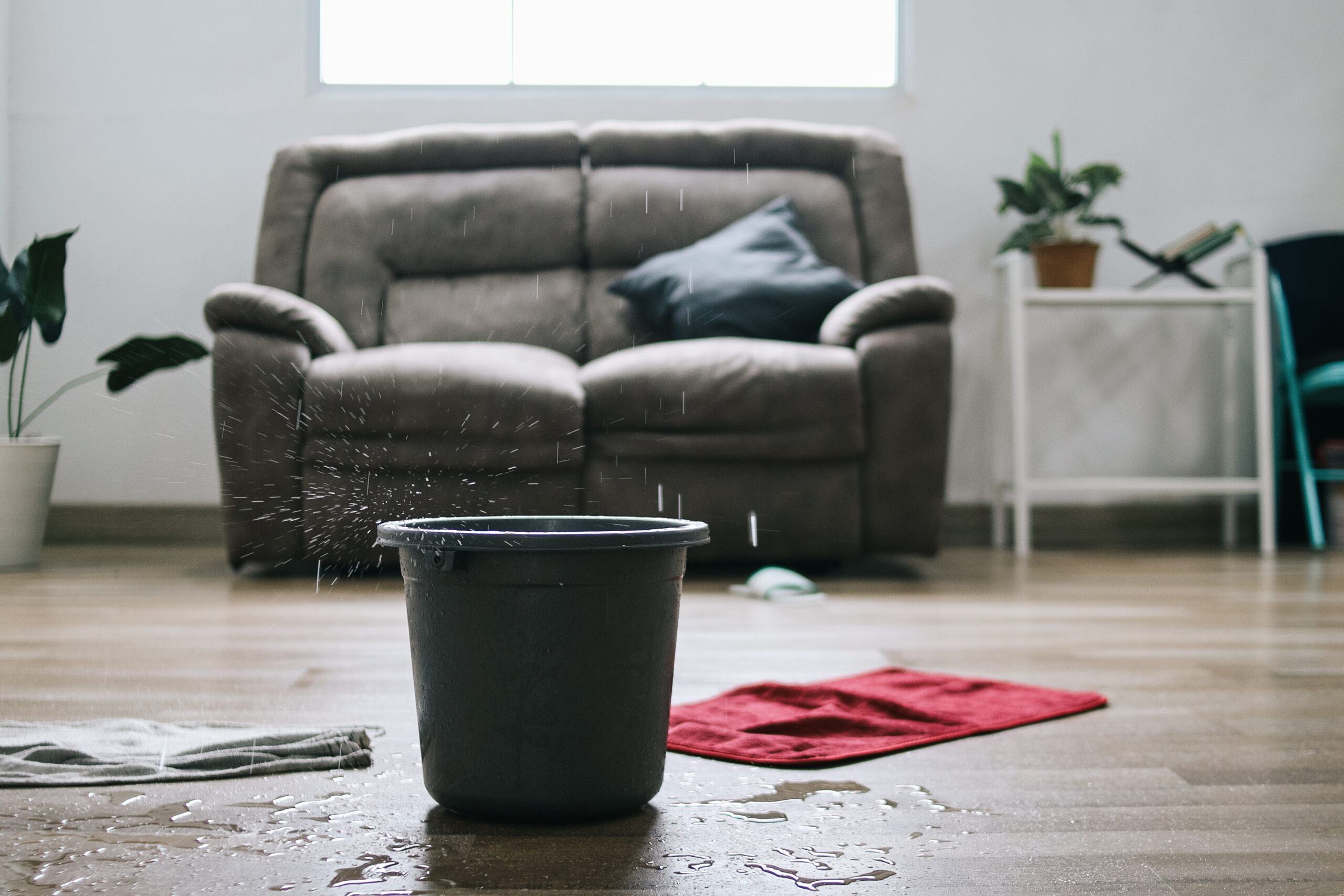 Water leaks into a green bucket