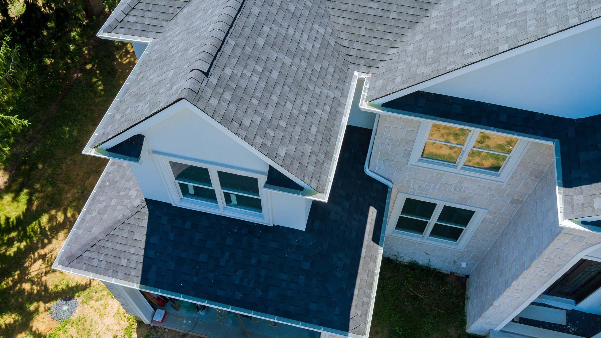 Overhead view of large luxury home with asphalt roof