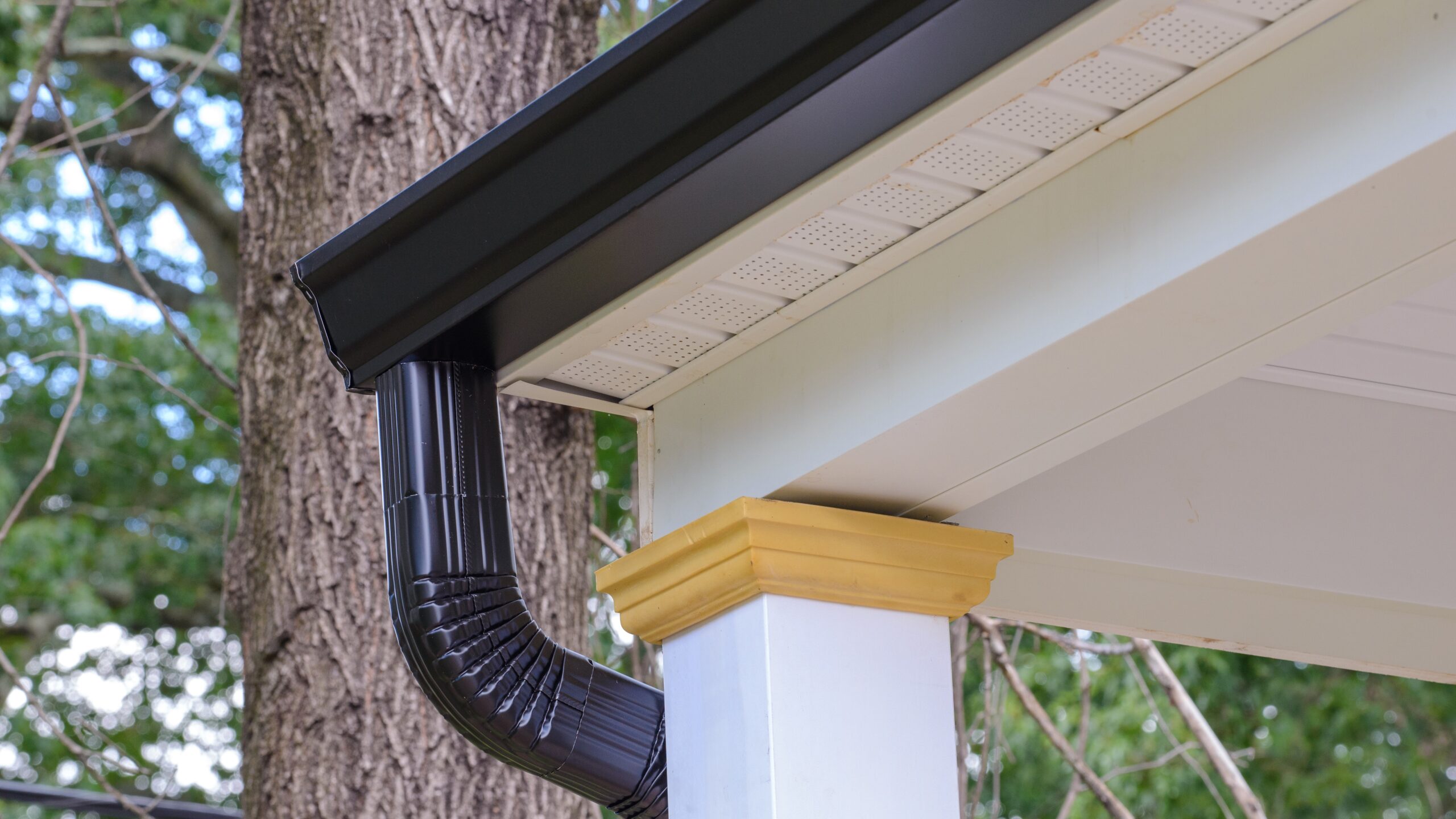 Home corner with dark seamless steel gutters