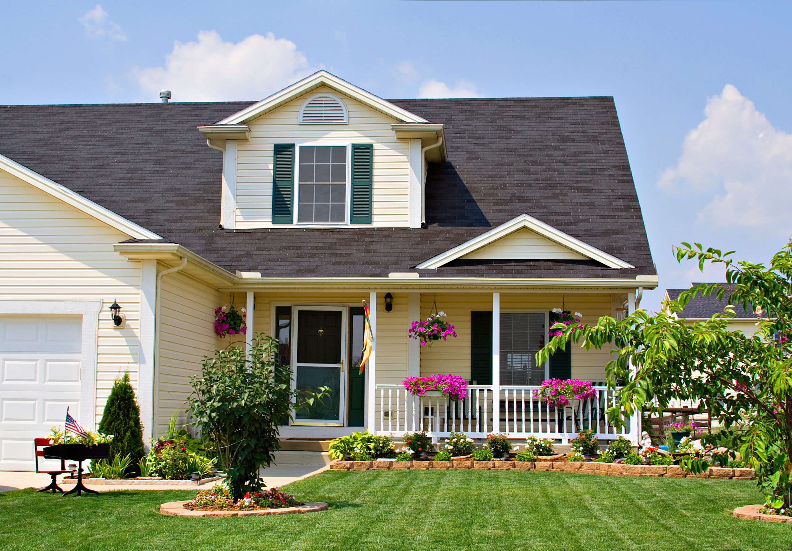 Two-story yellow house with an asphalt shingle roof