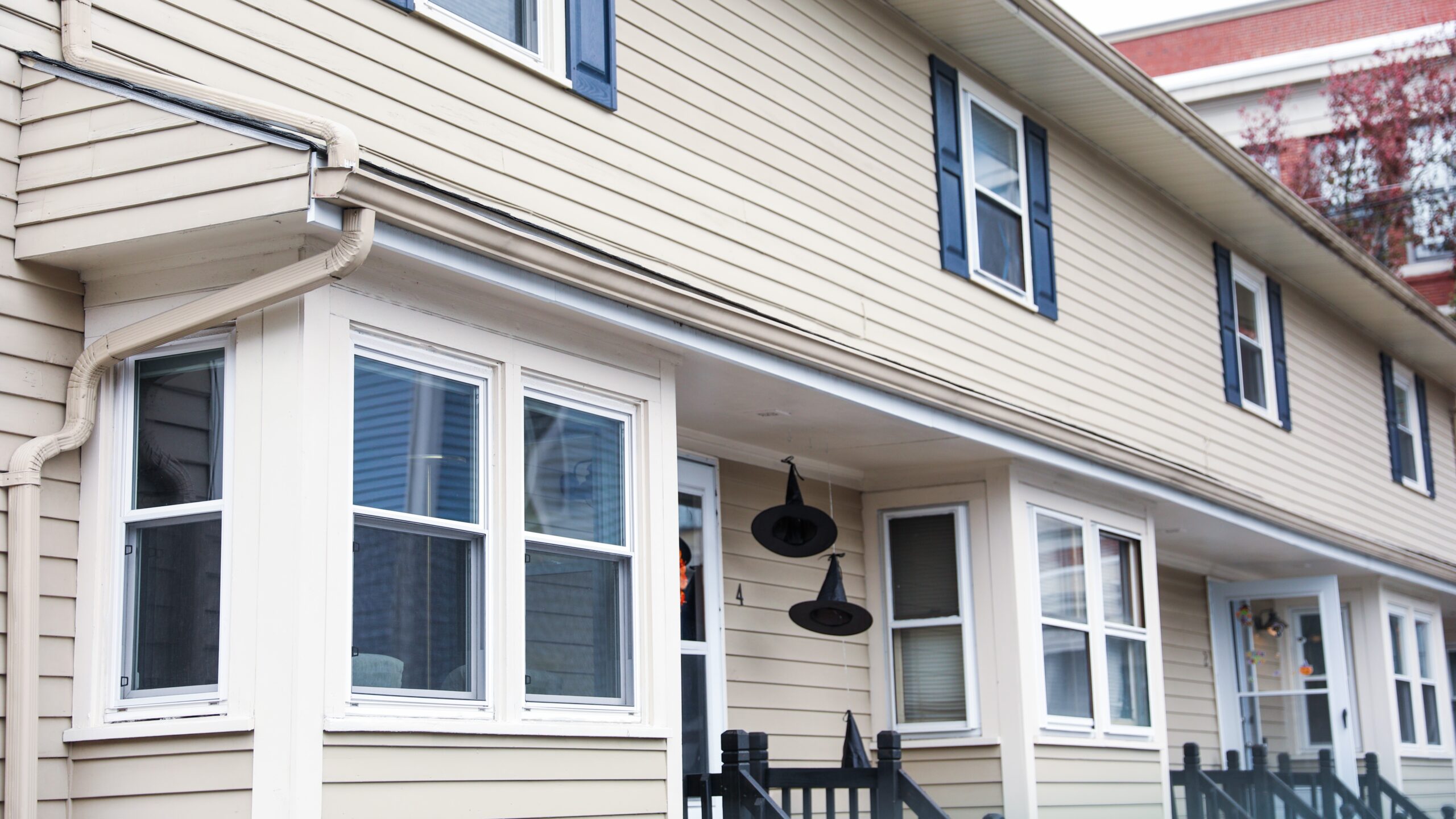 Side of home with beautiful off-white siding and lots of windows with white frames
