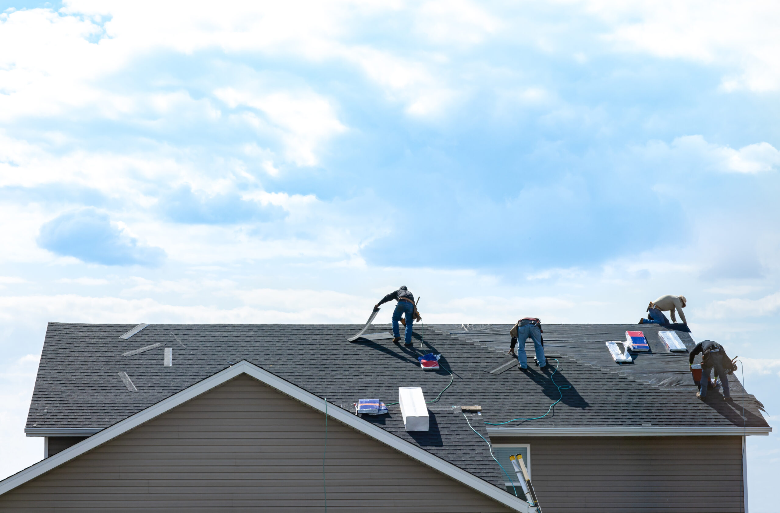 Roofers installing a new roof on a house