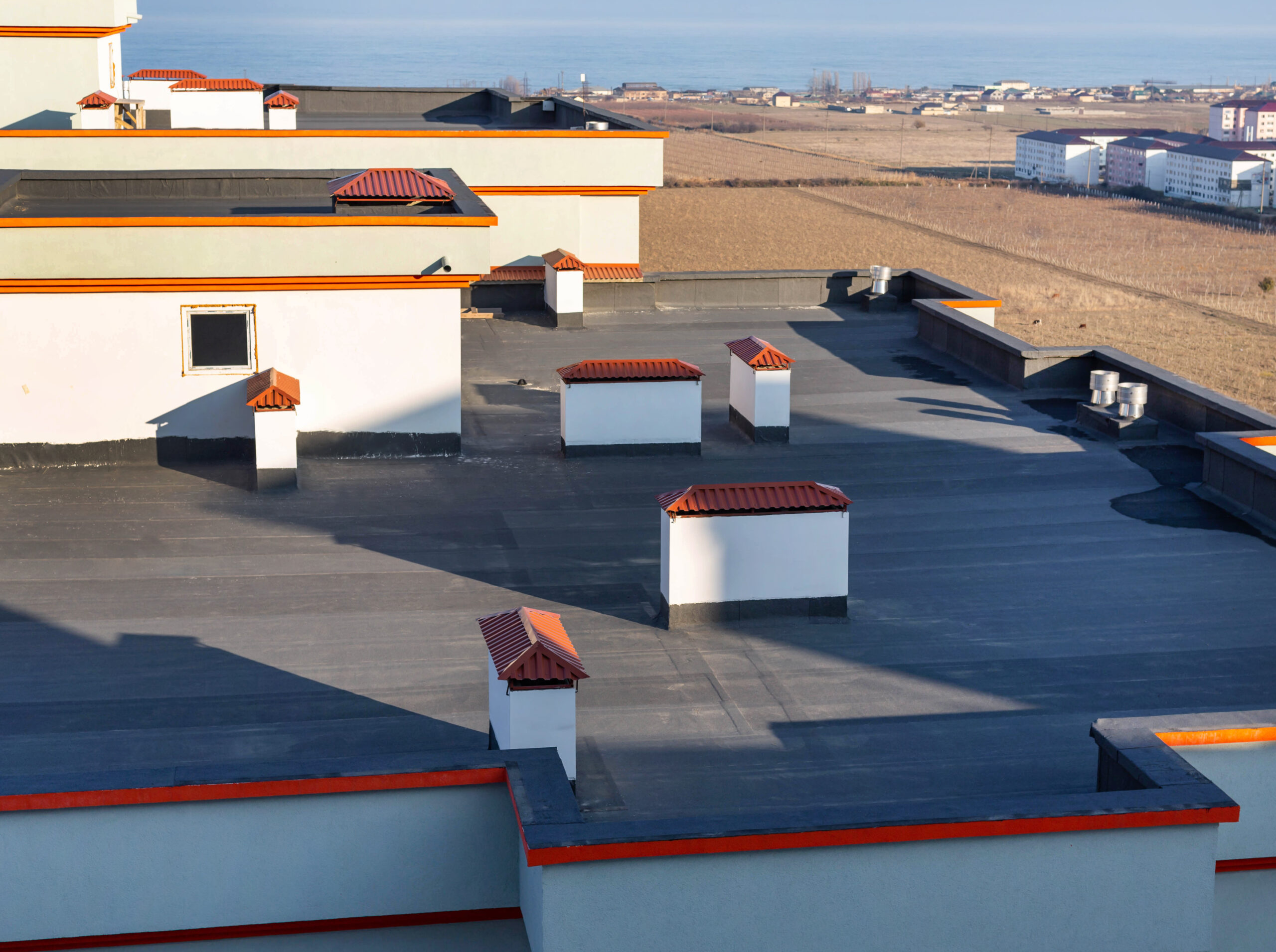 A high-up shot of a large, well-built flat commercial roof.