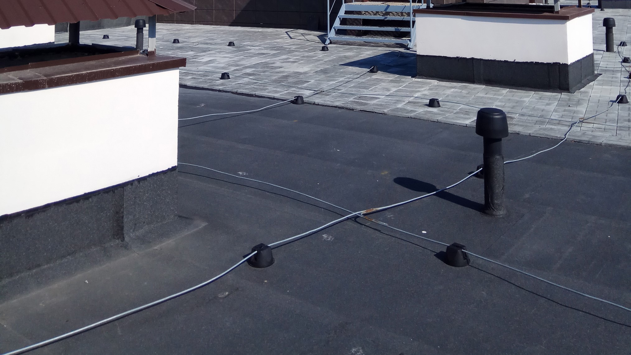 Top of a commercial building with black flat roofing.