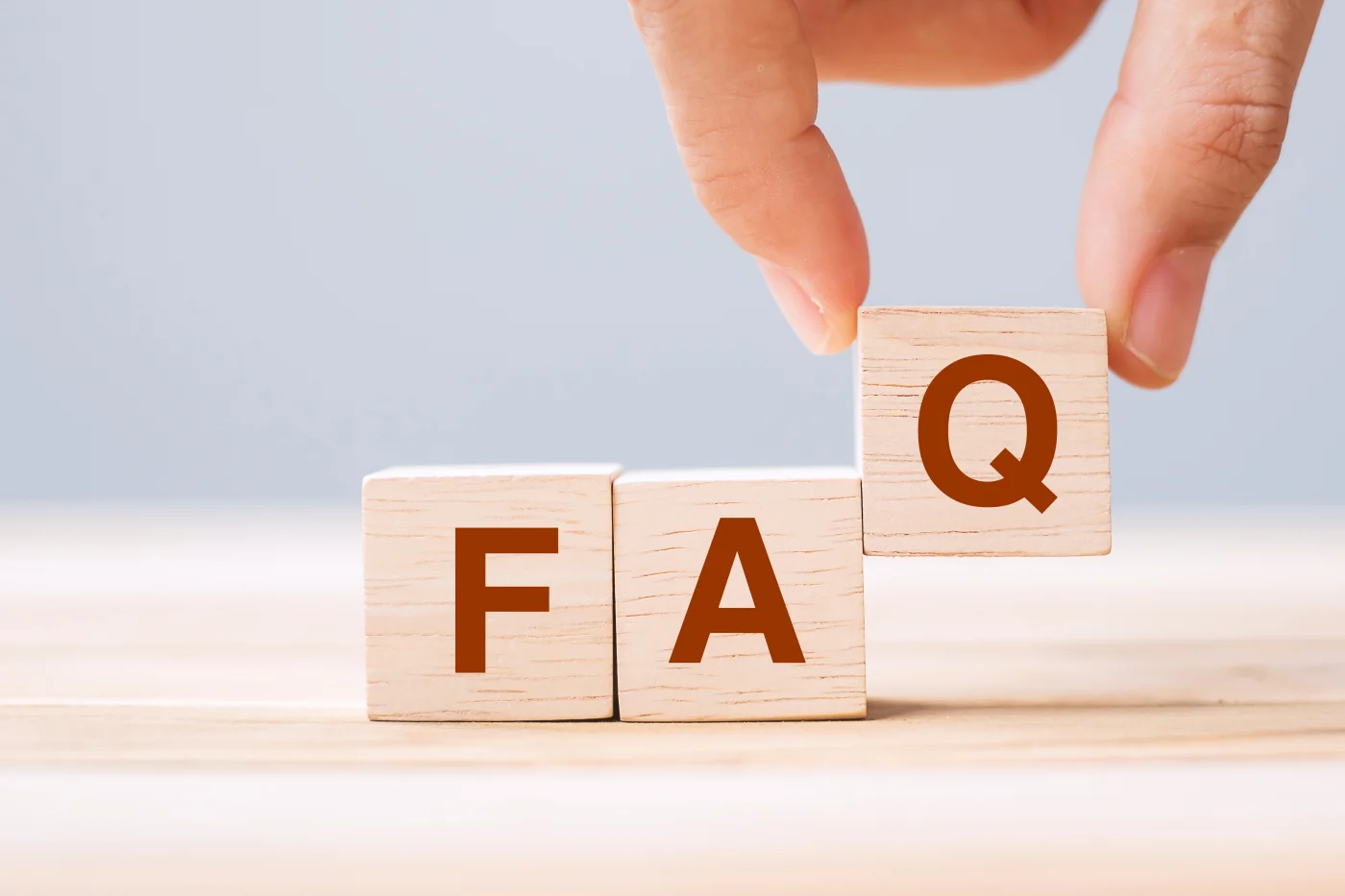Three blocks that are arranged to spell “FAQ”