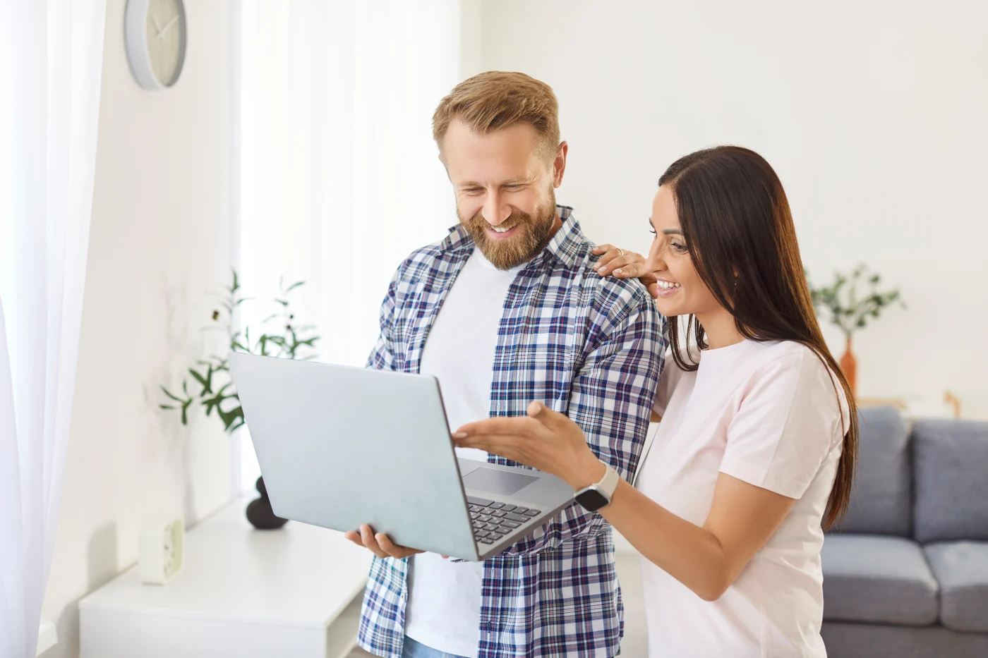 Happy homeowners on their laptop | ulsa Roofing Services | GoldenRite Roofing
